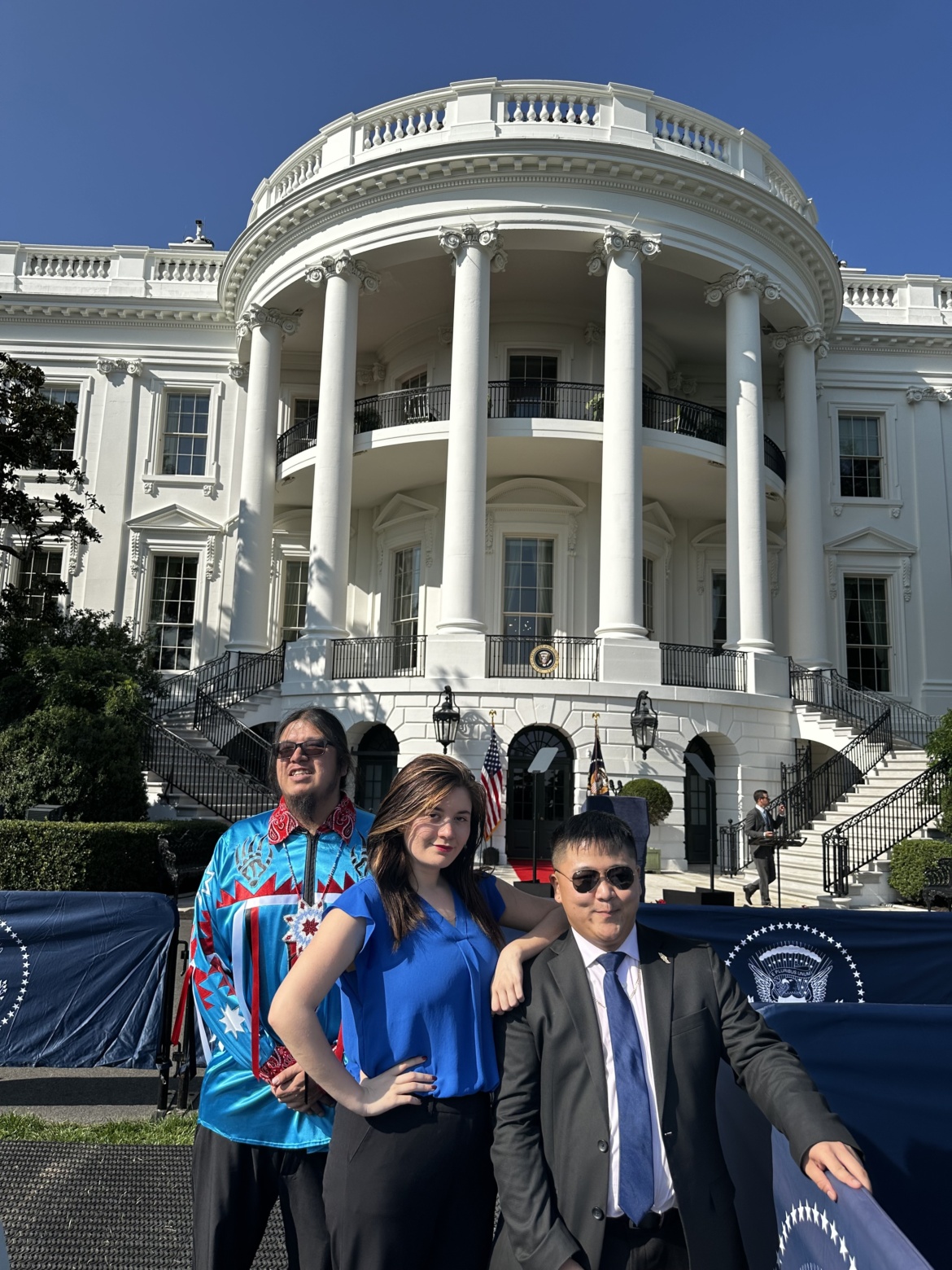 Three DAI Young Adult Leaders pose in front of the White House.